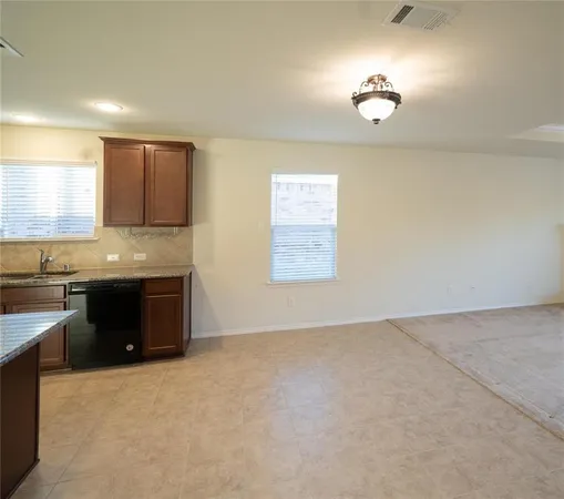 a kitchen with granite countertop a stove a sink and a microwave