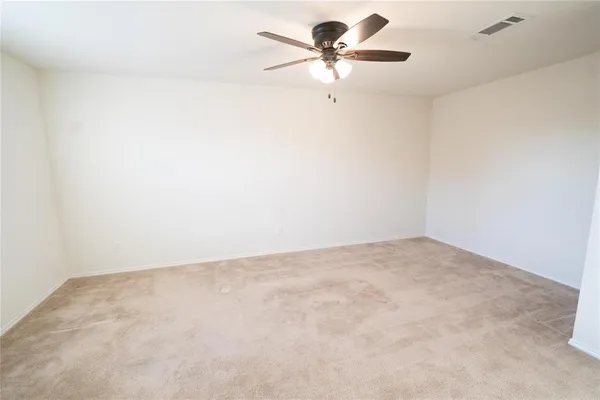 an empty room with a empty space and a ceiling fan