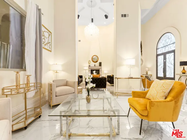 a view of a balcony with dining table and chairs