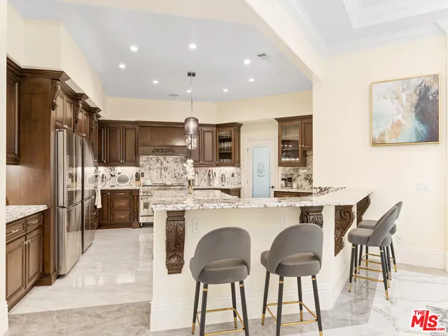 a living room with kitchen island furniture and a chandelier
