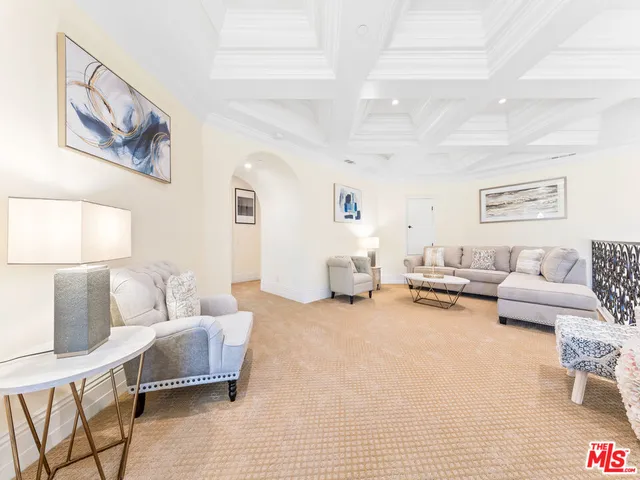 a bedroom with a bed ceiling fan and a large window