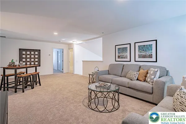 a living room with furniture a rug and a window