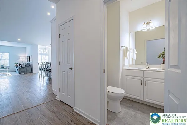 a bathroom with a toilet sink and a mirror