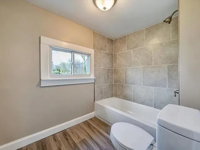 a bathroom with a toilet a sink and a shower