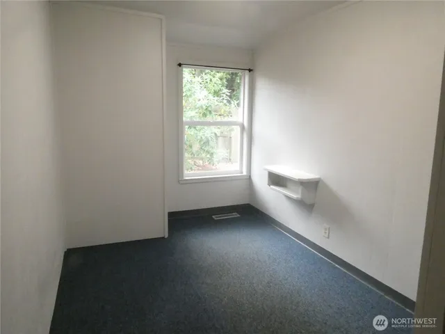 a front view of a house with a tree