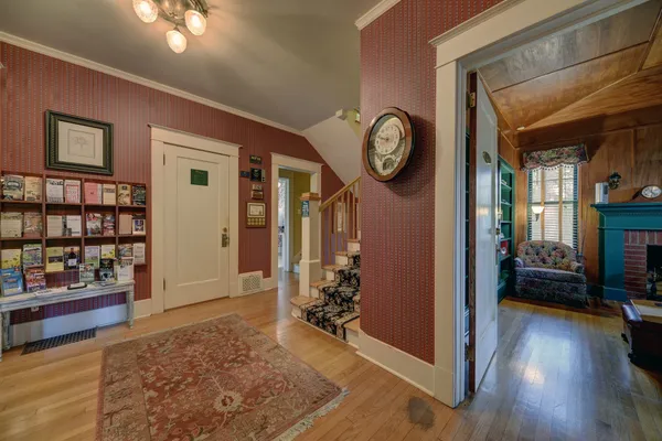 a view of a livingroom kitchen and hall with wooden floor