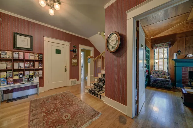 a view of a livingroom kitchen and hall with wooden floor