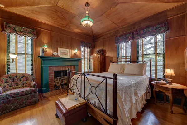 a spacious bedroom with a bed and a chandelier
