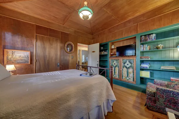 a bedroom with furniture and a flat screen tv