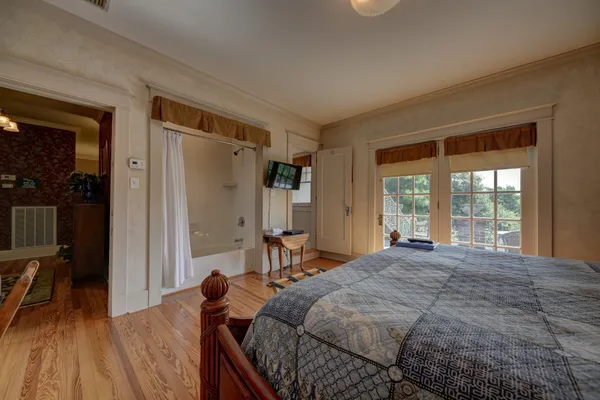 a bed sitting in a bedroom next to a window