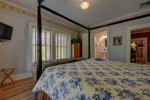 a bedroom with a bed and a flat screen tv
