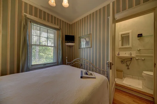 a bedroom with a bed and a window
