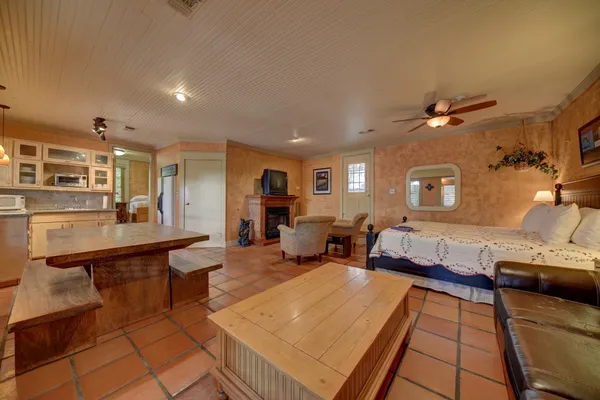 a living room with furniture a table and wooden floor
