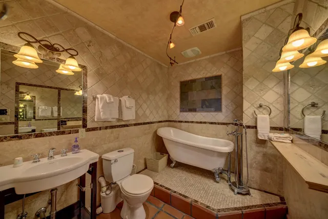 a bathroom with a sink mirror vanity and toilet