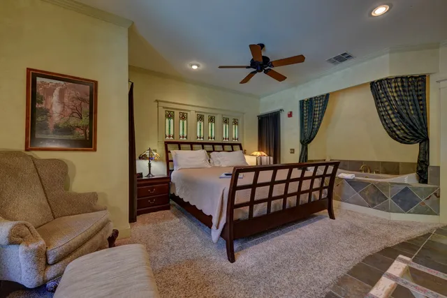 a bedroom with a bed rug and couch