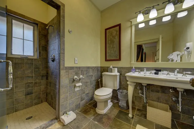 a bathroom with a sink toilet and shower