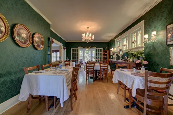 a view of a dining room with furniture and a large window