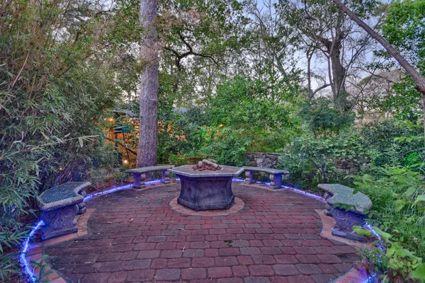 a view of a backyard with sitting area