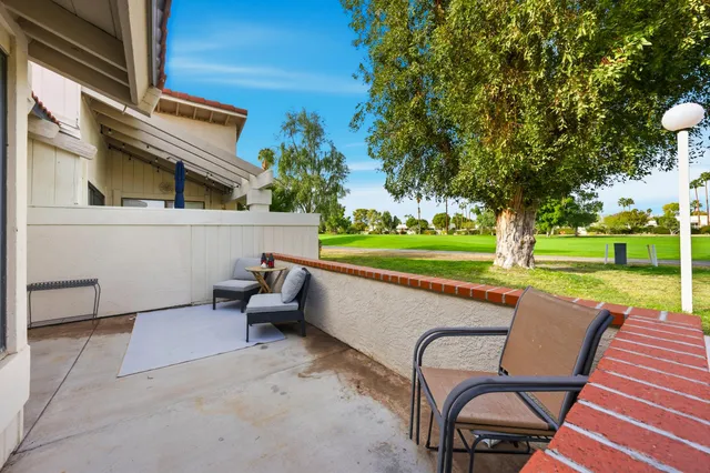 a view of a patio with a yard