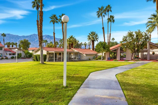 a view of a backyard with swimming pool