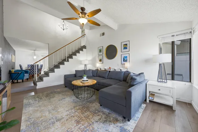 a living room with furniture and a clock