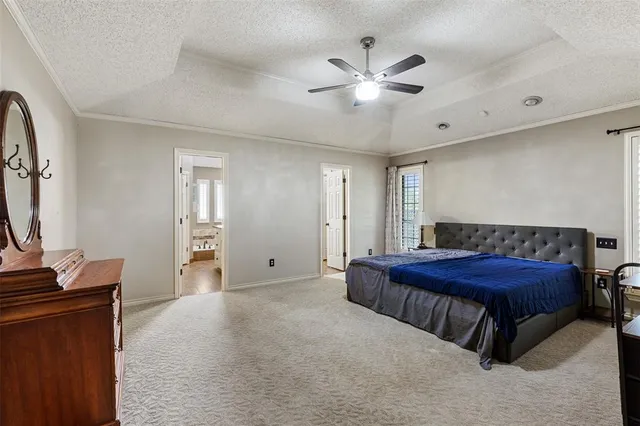 a spacious bedroom with a bed and a flat screen tv