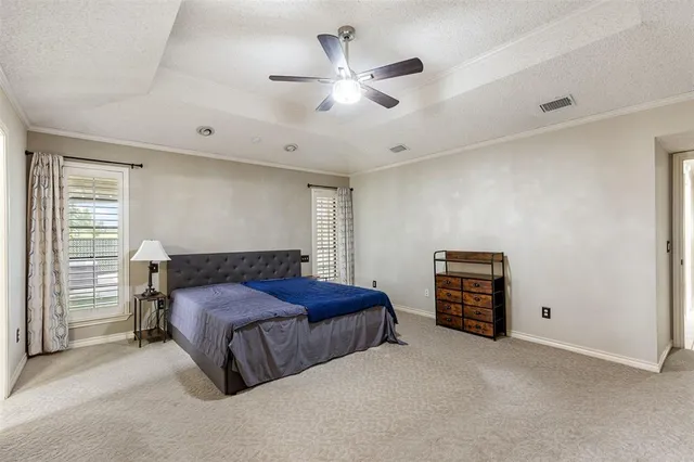 a bedroom with a bed and a ceiling fan