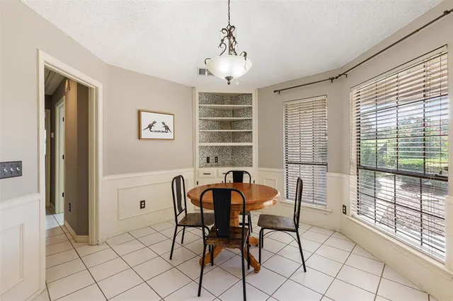 a view of a dining room with furniture and windows