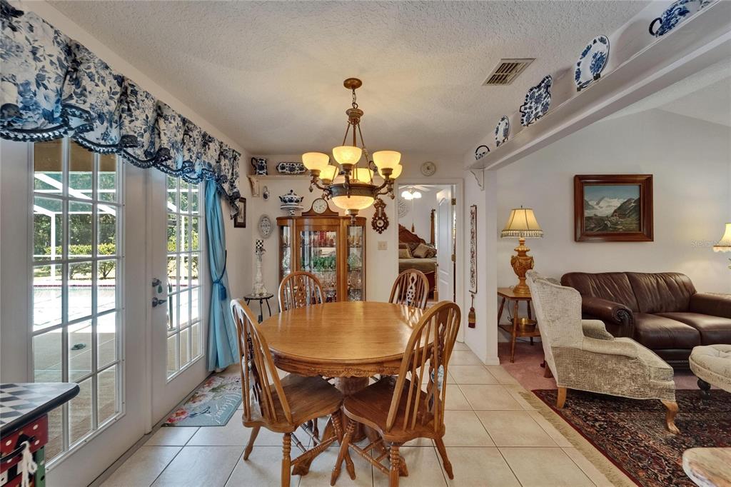 11120 Lu Wista Road Brooksville, FL 34601 - Photo 13 of 50 a view of a dining room with furniture and chandelier