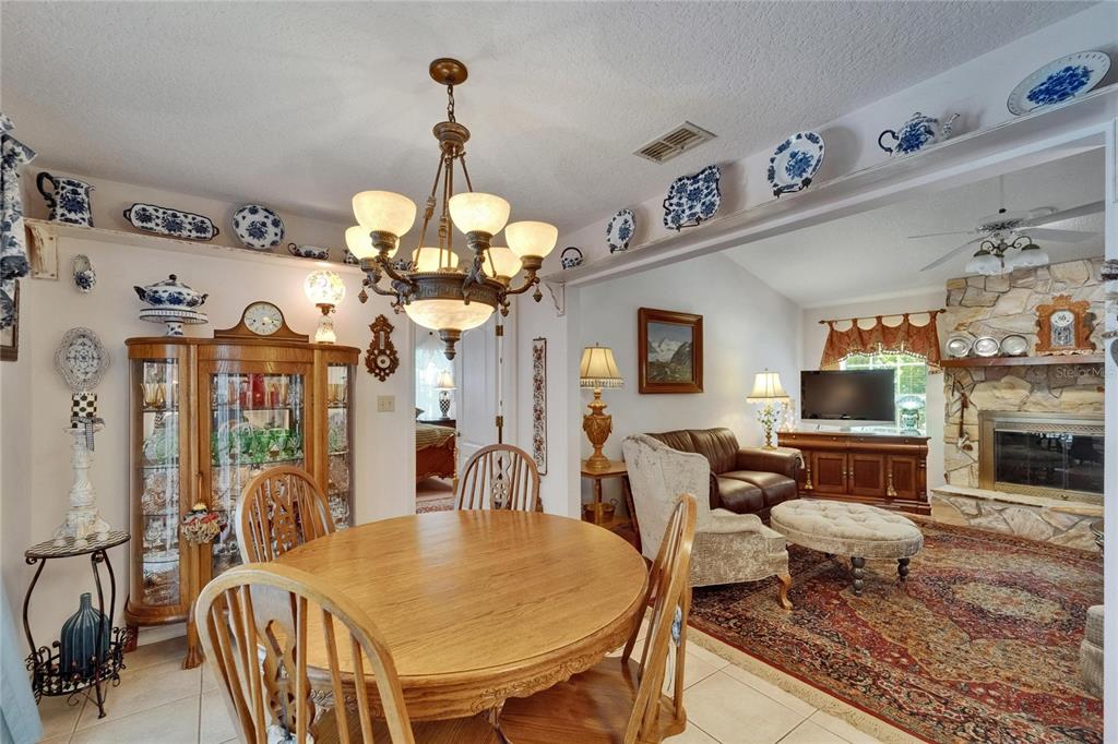 11120 Lu Wista Road Brooksville, FL 34601 - Photo 14 of 50 a living room with fireplace furniture and a chandelier