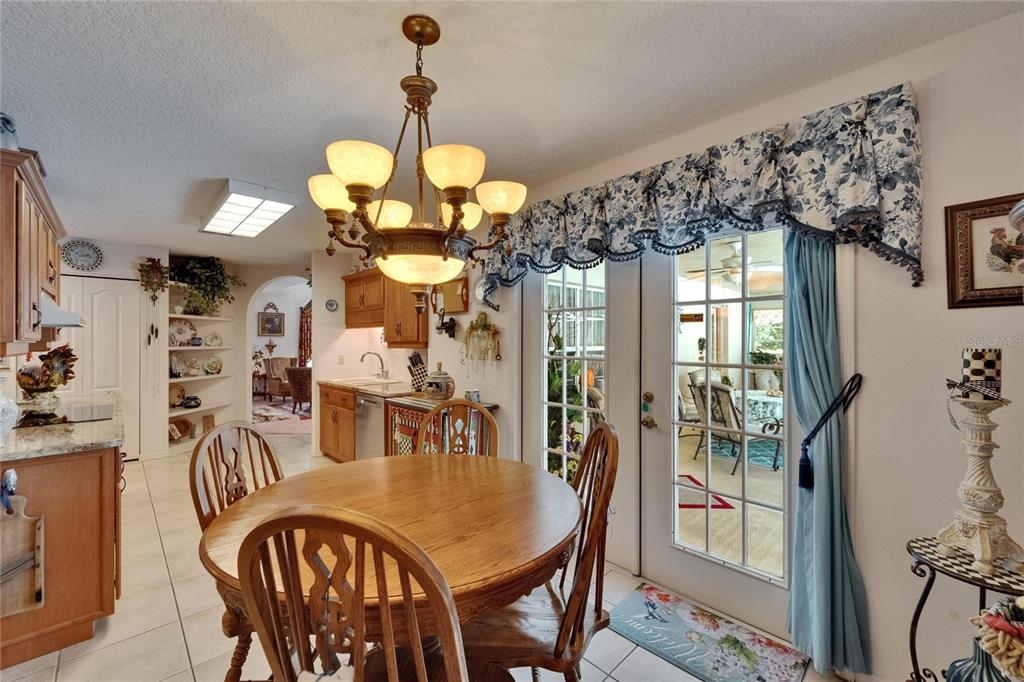 11120 Lu Wista Road Brooksville, FL 34601 - Photo 15 of 50 a view of a dining room with furniture and chandelier