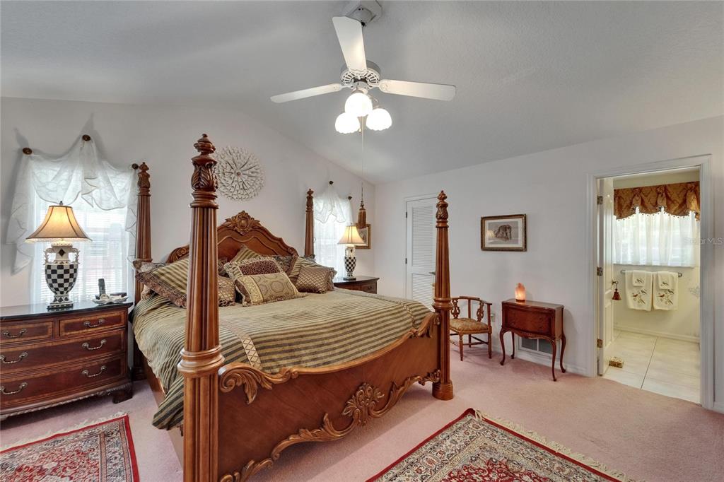 11120 Lu Wista Road Brooksville, FL 34601 - Photo 20 of 50 a bedroom with a bed and a chandelier
