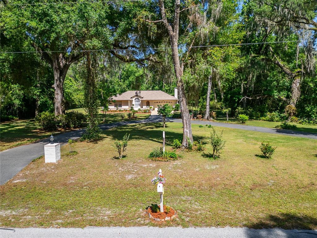 11120 Lu Wista Road Brooksville, FL 34601 - Photo 2 of 50 a swimming pool with outdoor seating and yard