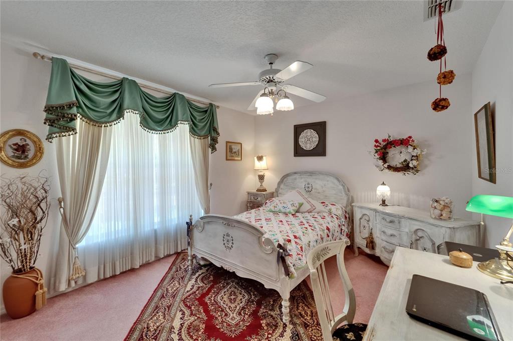 11120 Lu Wista Road Brooksville, FL 34601 - Photo 23 of 50 a bedroom with a bed and a chandelier
