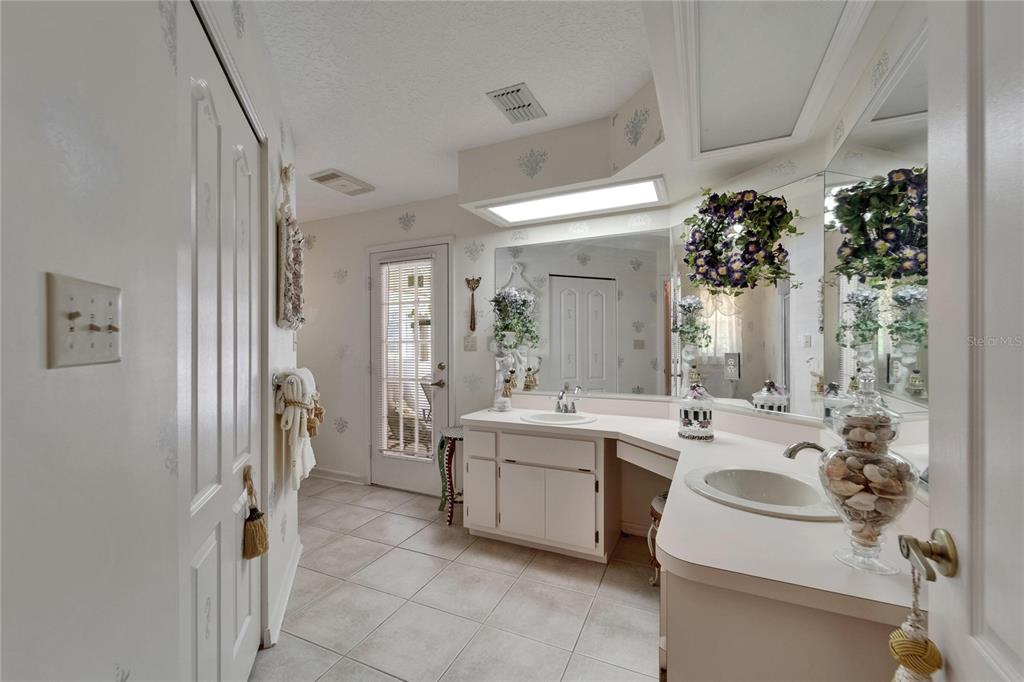 11120 Lu Wista Road Brooksville, FL 34601 - Photo 25 of 50 a bathroom with a sink a mirror and a shower