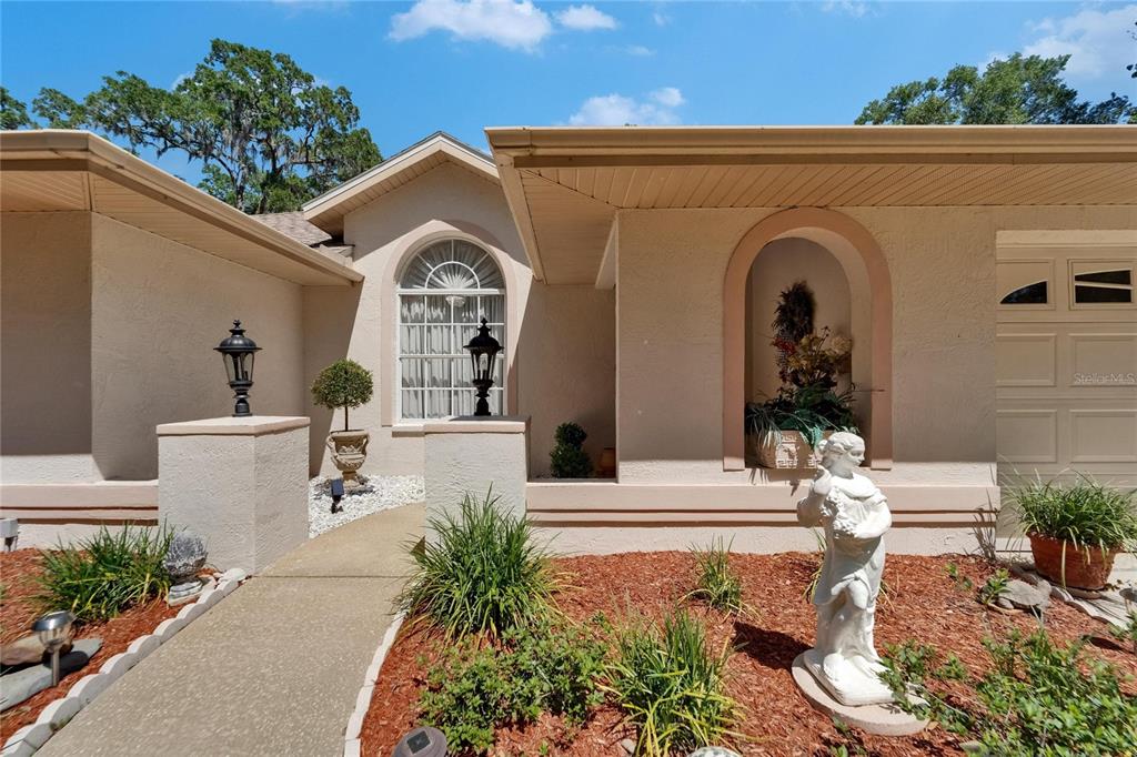 11120 Lu Wista Road Brooksville, FL 34601 - Photo 4 of 50 a front view of a house with garden