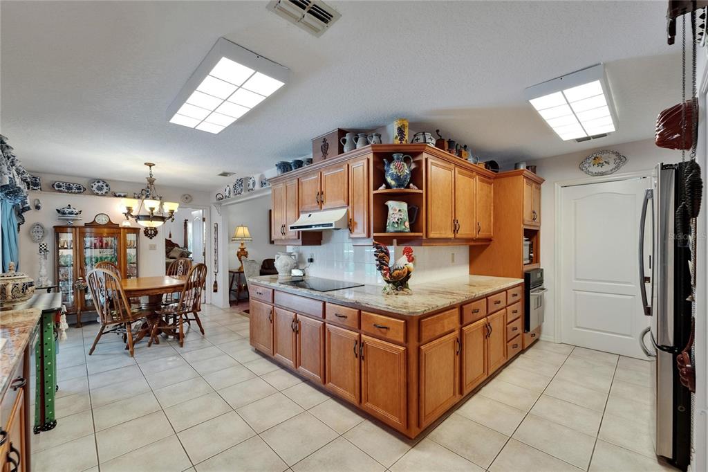 11120 Lu Wista Road Brooksville, FL 34601 - Photo 10 of 50 a kitchen with stainless steel appliances granite countertop a stove and a refrigerator