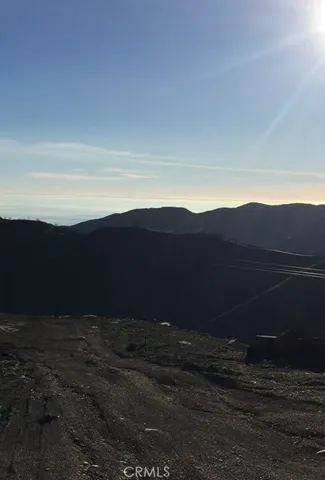 a view of an ocean and a mountain