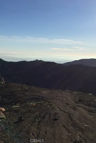 a view of a backyard with wooden fence