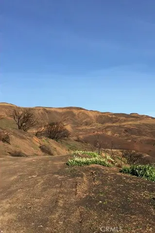 a view of a mountain range in a cloudy sky