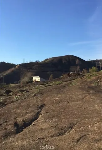 a view of a dry yard with mountains