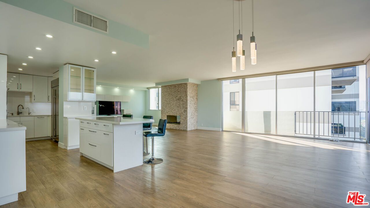 a large white kitchen with a large window