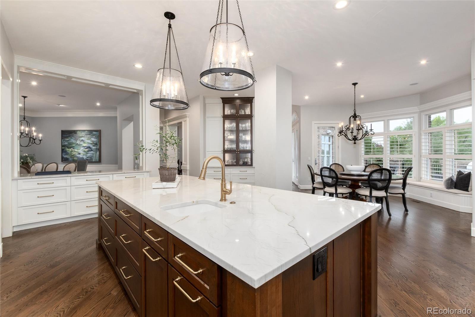 7175 Polo Ridge Drive Littleton, CO 80128 - Photo 11 of 50 a large kitchen with kitchen island a large island in the center