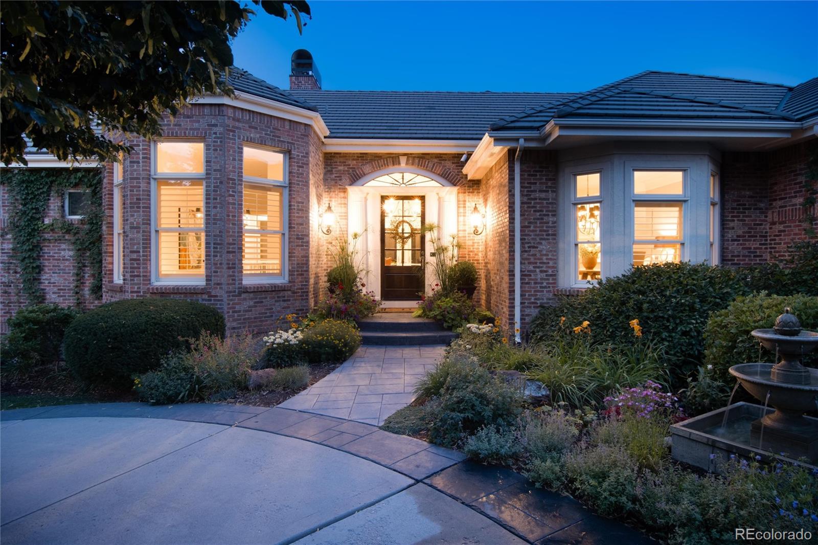 7175 Polo Ridge Drive Littleton, CO 80128 - Photo 2 of 50 a view of a house with a large windows and flower plants