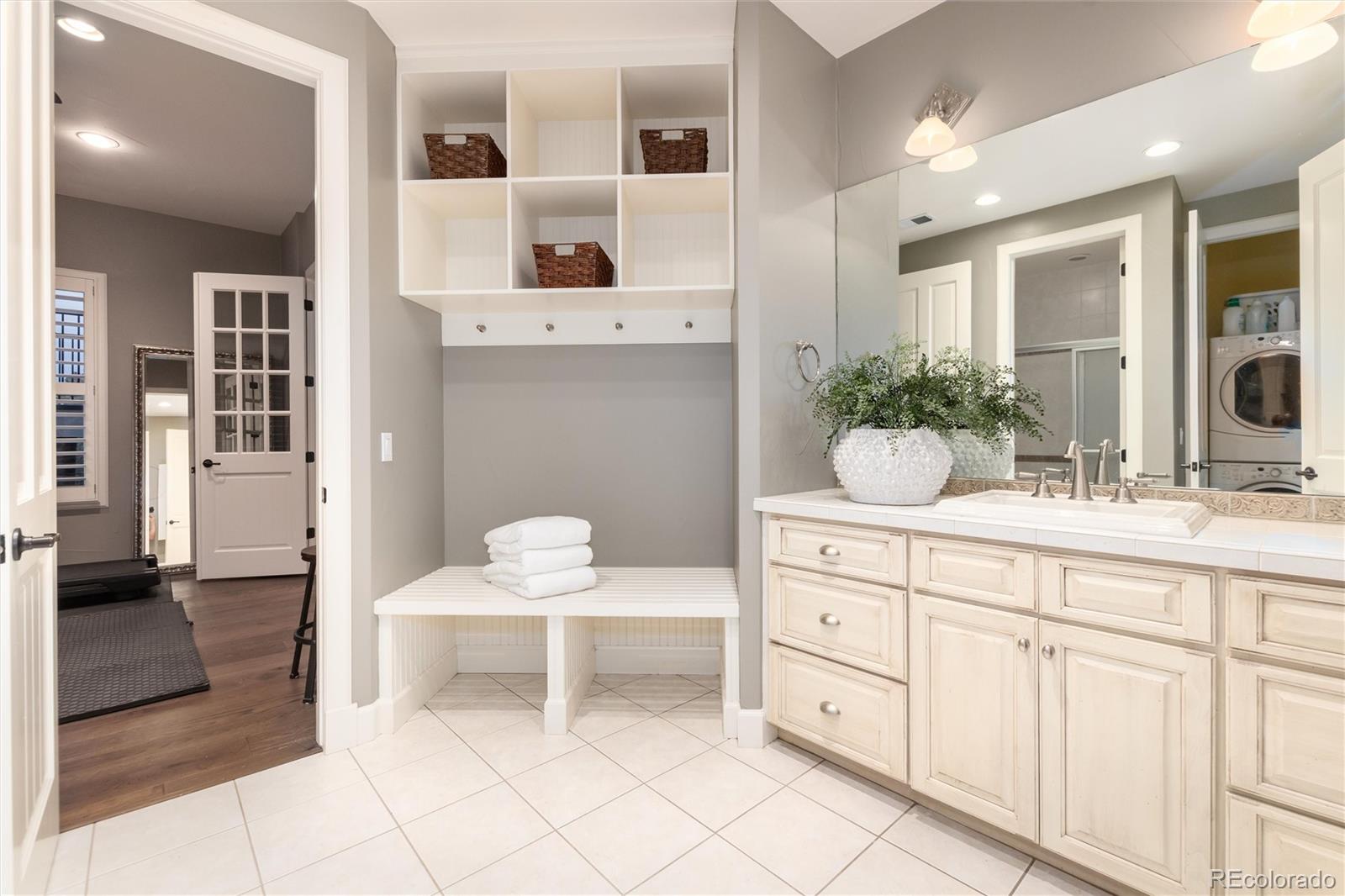 7175 Polo Ridge Drive Littleton, CO 80128 - Photo 32 of 50 a spacious bathroom with a double vanity sink and a mirror