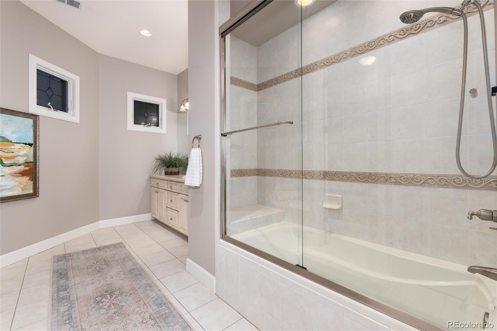 7175 Polo Ridge Drive Littleton, CO 80128 - Photo 36 of 50 a bathroom with a bathtub and a shower