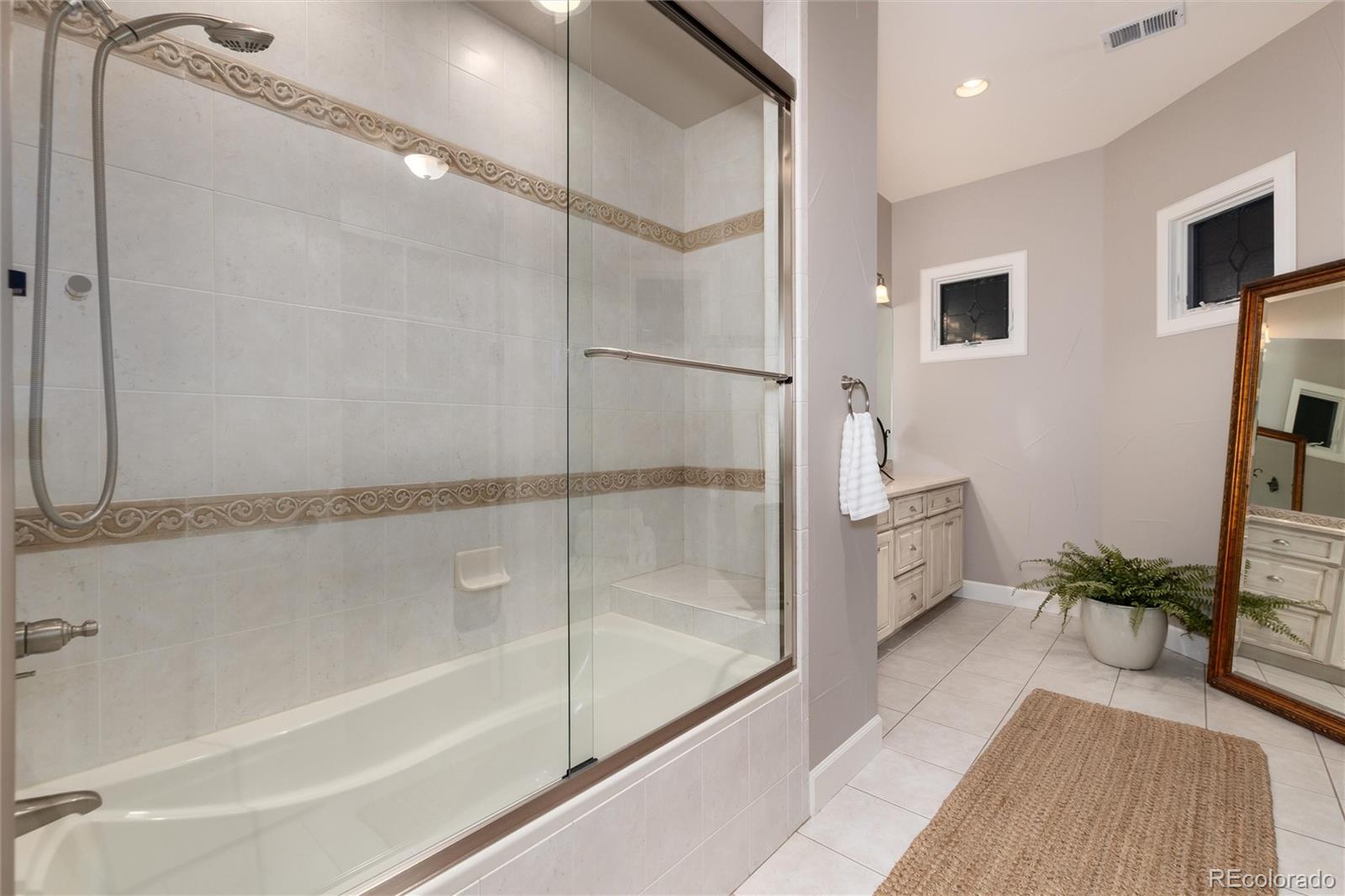 7175 Polo Ridge Drive Littleton, CO 80128 - Photo 38 of 50 a bathroom with a tub and shower