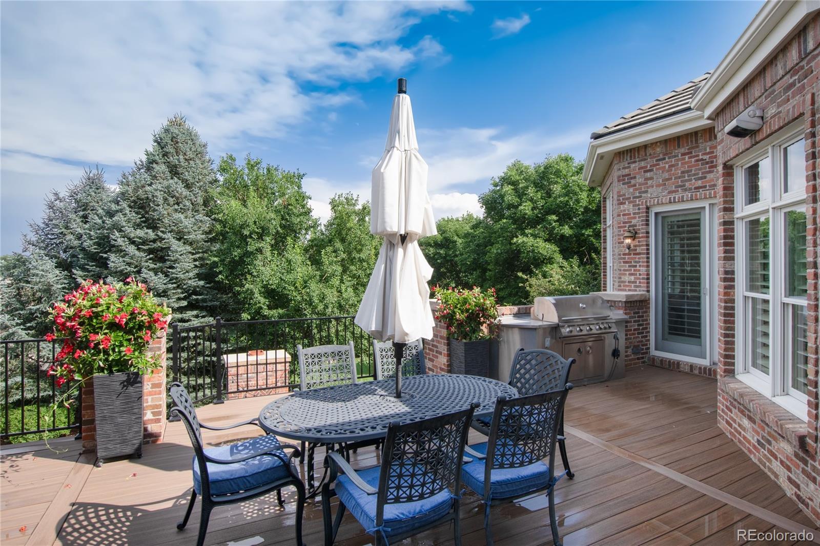 7175 Polo Ridge Drive Littleton, CO 80128 - Photo 39 of 50 a view of a patio with a table and chairs