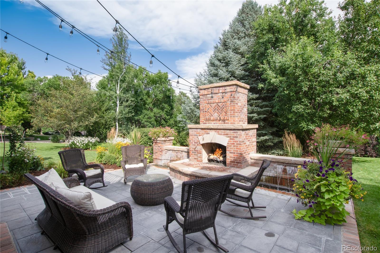 7175 Polo Ridge Drive Littleton, CO 80128 - Photo 41 of 50 a view of a patio with couches table and chairs and potted plants