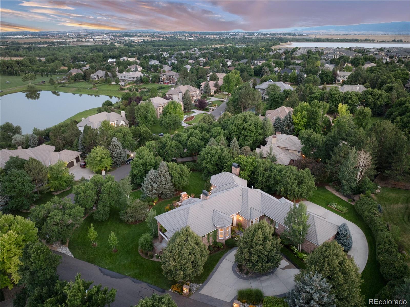 7175 Polo Ridge Drive Littleton, CO 80128 - Photo 45 of 50 an aerial view of a house with a garden and lake view